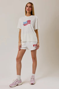 White oversized round neck t shirt with usa flag graphic in red and blue on the chest for casual wear