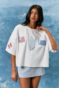 White oversized short sleeve americana t shirt with embroidered american flag swimsuit and denim shorts patches