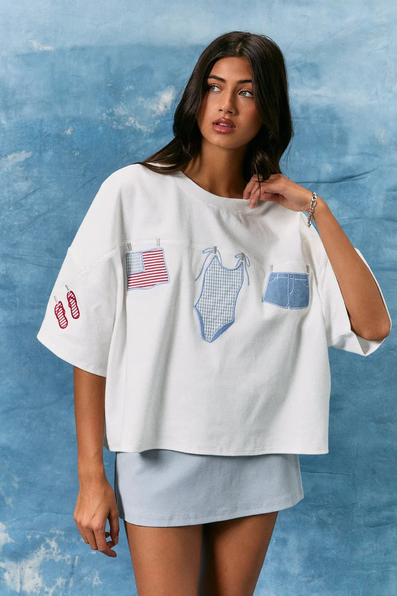 White oversized short sleeve americana t shirt with embroidered american flag swimsuit and denim shorts patches