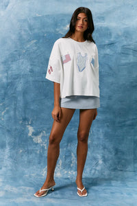 White short sleeve americana graphic top with embroidered American flag and colorful swimsuit and flip-flop sleeve details