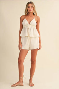 White peplum romper with gauze picot lace trim and lace v neck featuring thin spaghetti straps