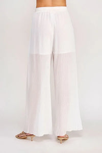 White pleated wide-leg textured woven pants with a sheer overlay and an elastic tie waist for adjustable fit