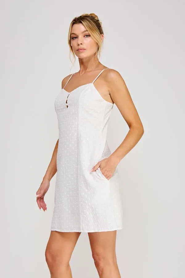 White polka-dot cotton spaghetti strap sweetheart mini dress with front button detail and thin straps