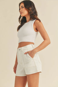 White ribbed sleeveless crop top with high neckline paired with high rise utility cargo short in durable fabric