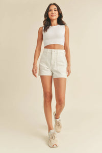 White ribbed crop top paired with high rise utility cargo short featuring functional pockets and casual style