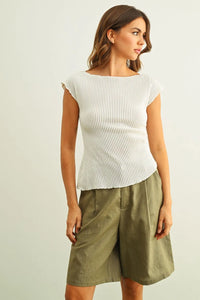 White crinkled fabric shirring cap sleeve top with ribbed knit texture and boat neckline in short sleeves