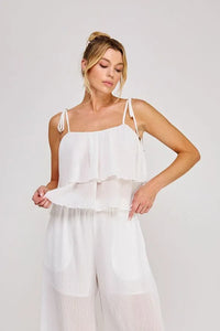 White ruffled camisole top with woven tie strap, textured woven tie, sheer layered fabric, and adjustable thin straps