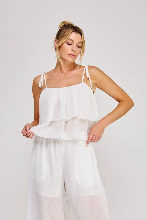 White ruffled camisole top with woven tie strap, textured woven tie, sheer layered fabric, and adjustable thin straps
