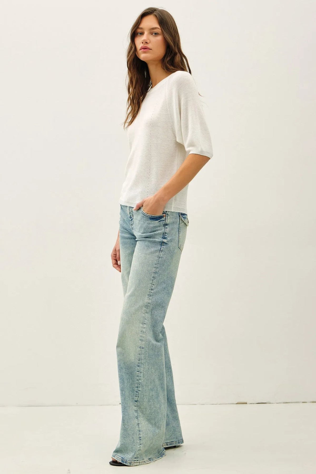 White lightweight ribbed knit raglan short sleeve top with loose fit puffed sleeves and subtle perforated detailing