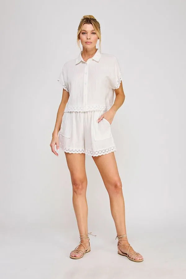 White linen blend drawstring waist short romper with delicate eyelet trim on collar sleeves and hem