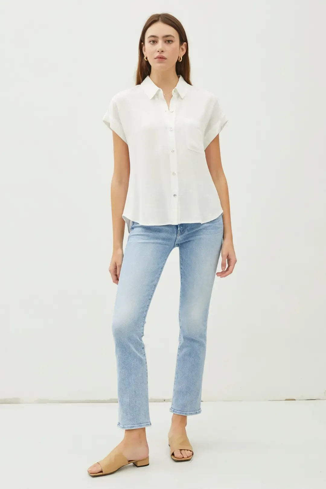 White solid short sleeve button down shirt with classic collar and slightly flared high low hem for versatile wear