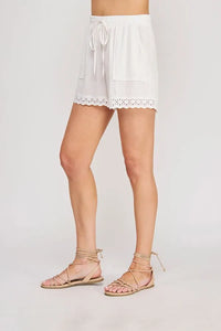 White linen blend drawstring waist shorts with delicate eyelet trim along the hem for a comfortable summer look