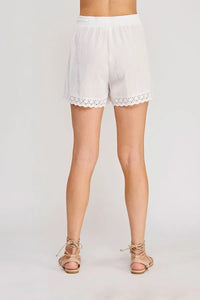 White linen blend drawstring waist shorts with delicate eyelet trim along the hem for a stylish summer look
