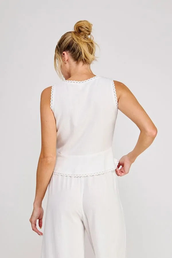 White sleeveless linen blend top with ties lace trim along neckline and waistband in women’s boho chic clothing style