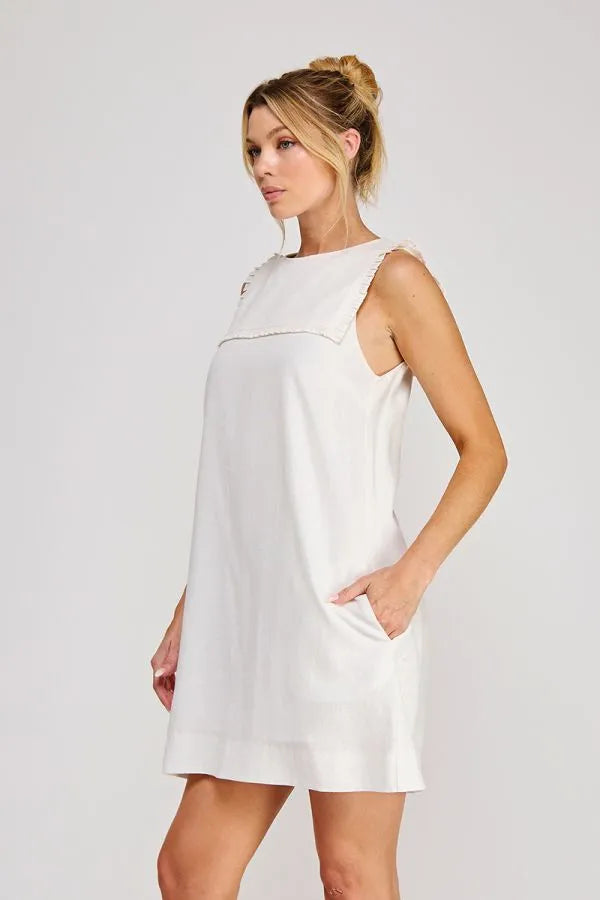 White linen blend sleeveless shift mini dress with relaxed fit and subtle neckline detailing