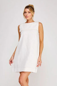 White linen blend sleeveless shift mini dress with frayed neckline and minimalist design for summer wear