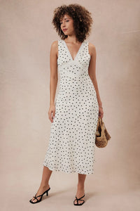 White sleeveless midi dress with black polka dots featuring a lace detail v neck sleeveless midi design