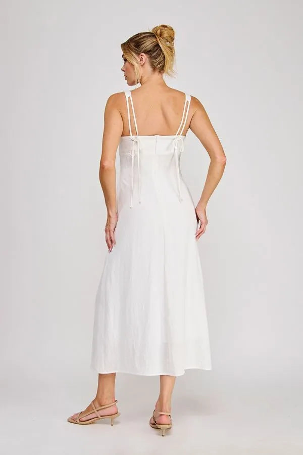 White sleeveless maxi dress with thin adjustable straps and back tie detail featuring a pleated bodice design