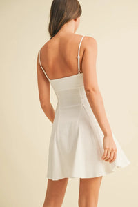 White sleeveless stretchy linen flare mini dress with thin straps and a flared skirt perfect for summer wear