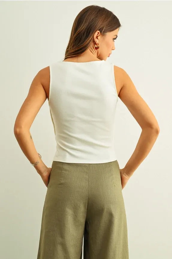 White sleeveless top with ribbed texture and button detail on the side in a fitted silhouette for women’s boho chic clothing