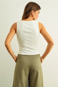 White sleeveless top with ribbed texture and button detail on the side in a fitted silhouette for women’s boho chic clothing