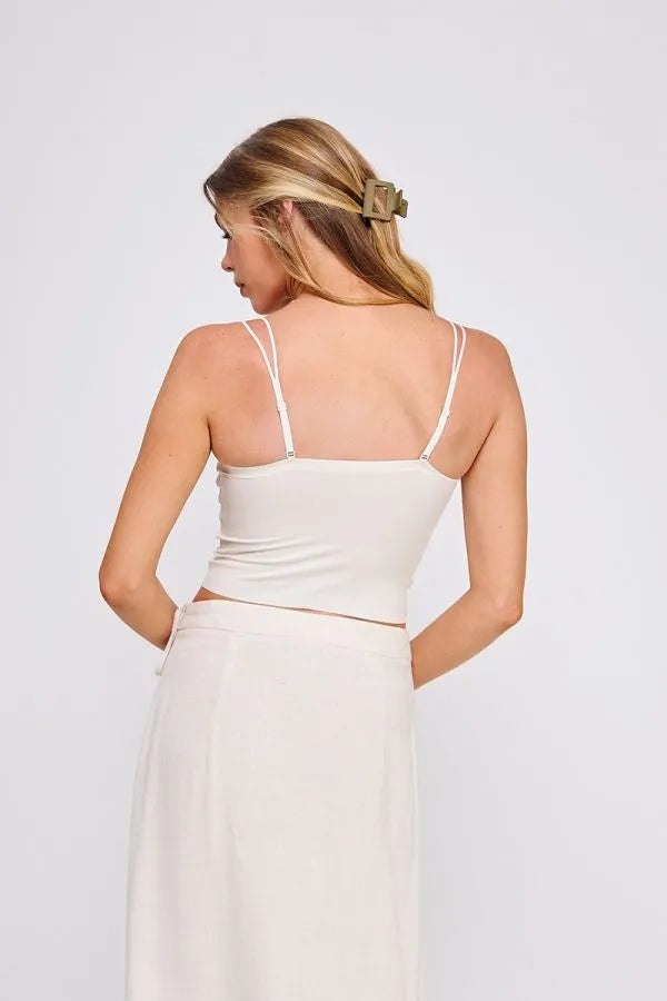 White spaghetti strap crop top featuring a fine lace pattern scallop design with delicate silver hardware accents