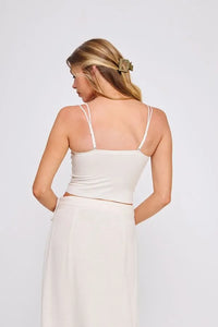 White spaghetti strap crop top featuring a fine lace pattern scallop design with delicate silver hardware accents