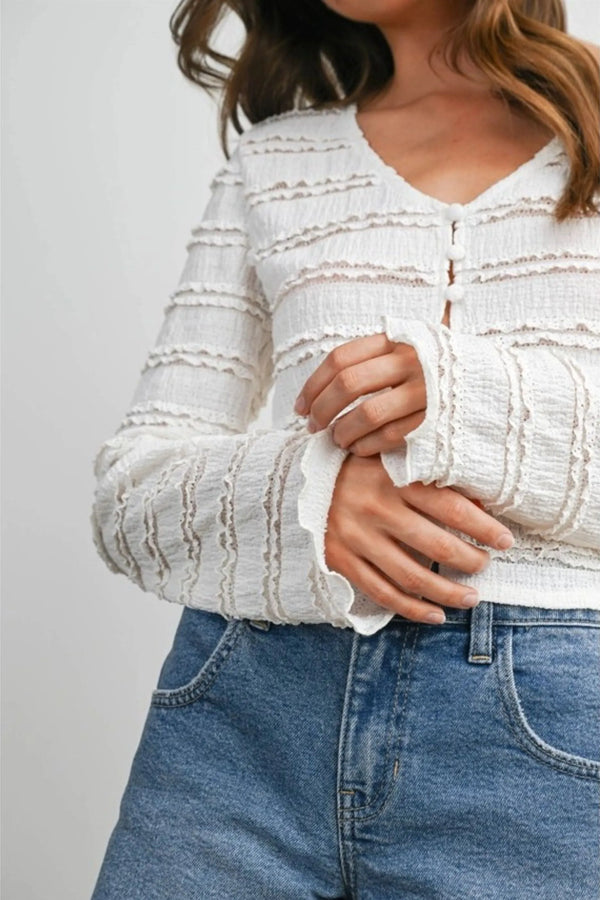 White textured ruched ribbon knit cardigan with ruffled cuffs and button-front closure