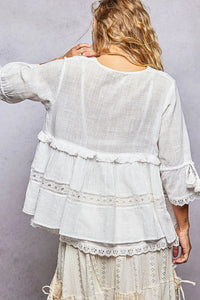 White relaxed fit boho v neck half sleeve blouse with tiered lace trim and ruffled sleeves