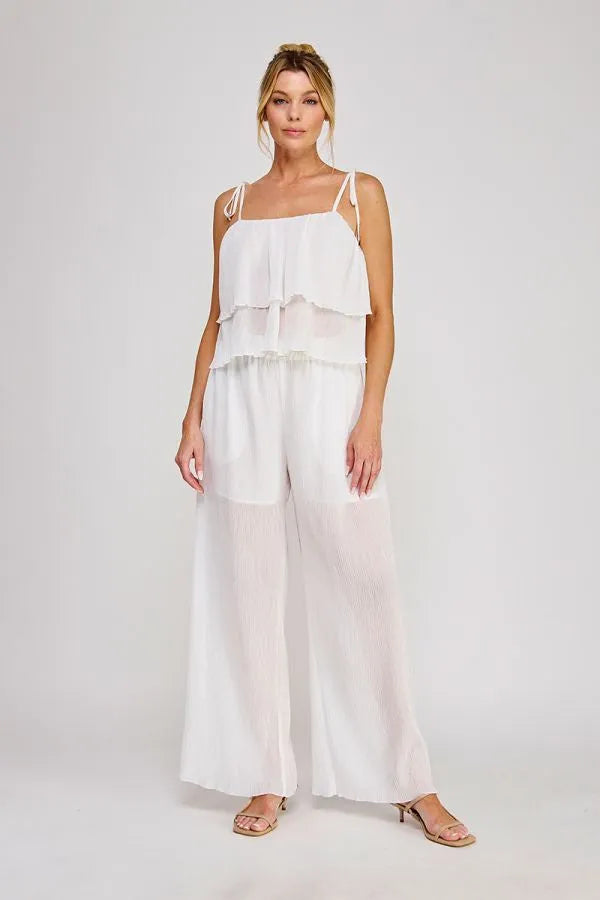 White tiered chiffon jumpsuit with elastic tie waist and textured woven fabric featuring wide-leg pants and thin straps