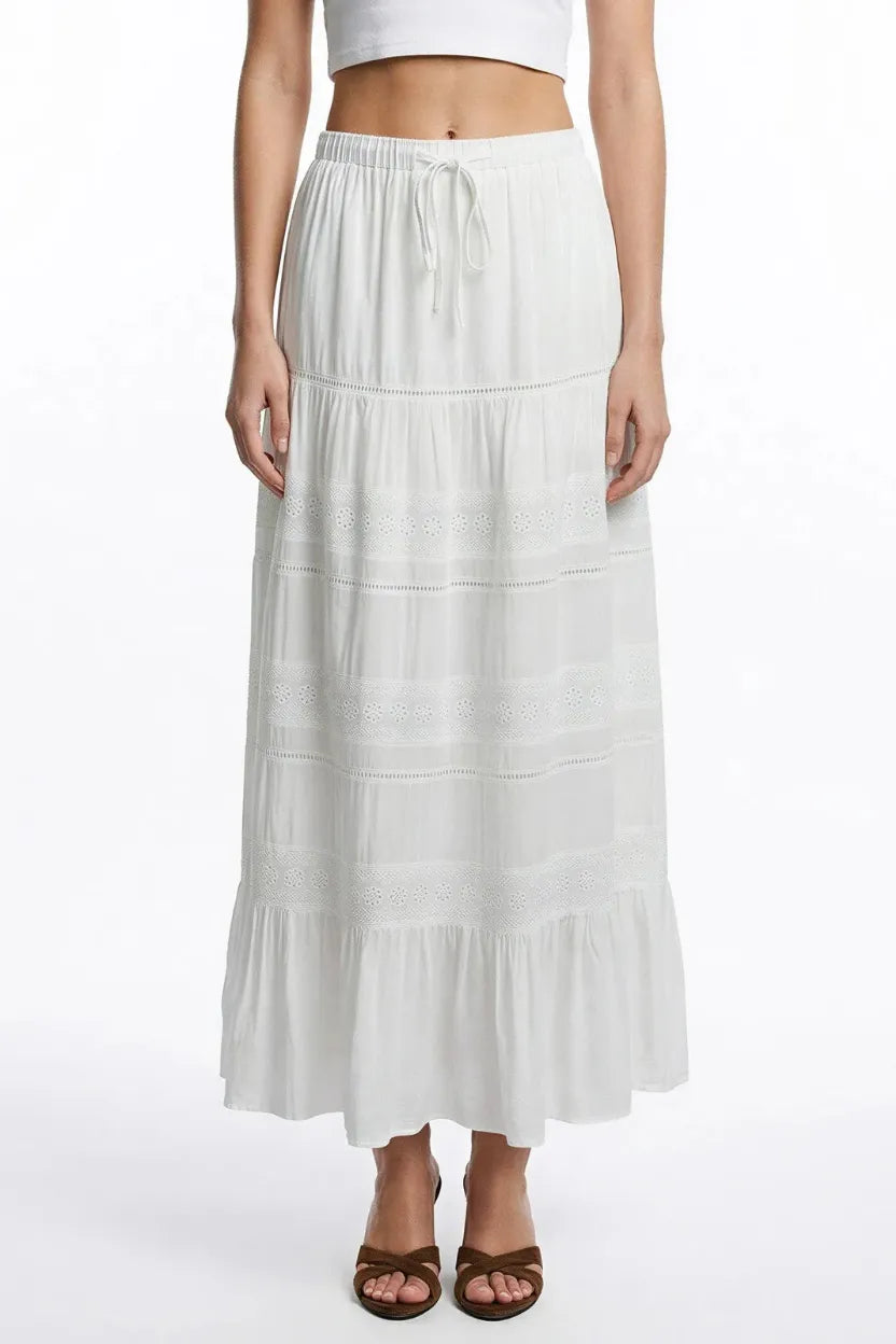 White boho breeze tiered maxi skirt with delicate eyelet embroidery and elastic waistband for comfortable wear