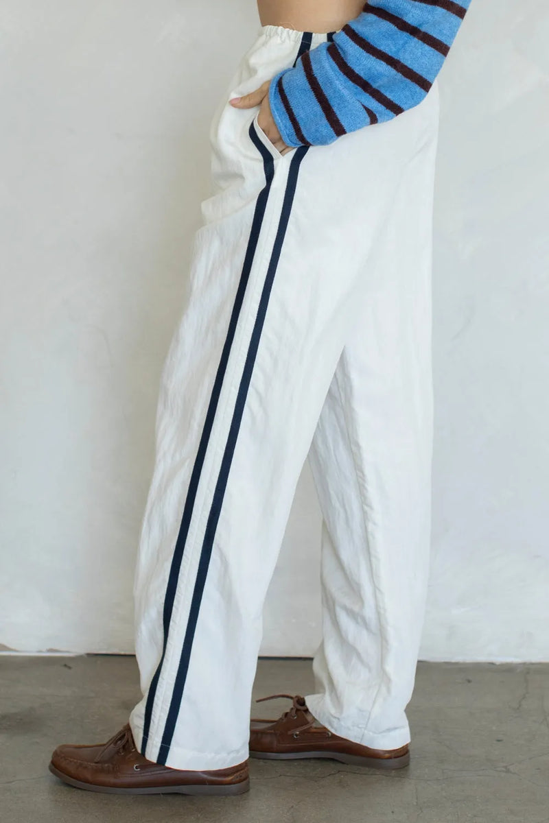 Landon track pocket side double line pants in white with two vertical navy blue stripes for casual athletic wear