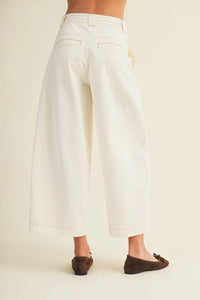 White pull on baggy fit pants featuring wide-leg cropped design with clean minimalist style and subtle stitching details
