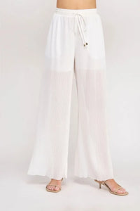 White textured woven wide leg pants with elastic tie waist and sheer pleated lower panels for stylish comfort