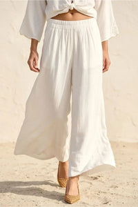 White linen blend wide leg pants with elastic waistband and subtle pleats featuring a soft hand feel