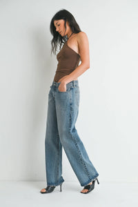 Low rise baggy slouchy denim jeans with wide-leg cut faded blue wash and frayed hems in soft denim fabric