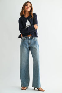 Low rise baggy wide leg denim jeans in medium-wash blue with subtle fading and detailed stitching