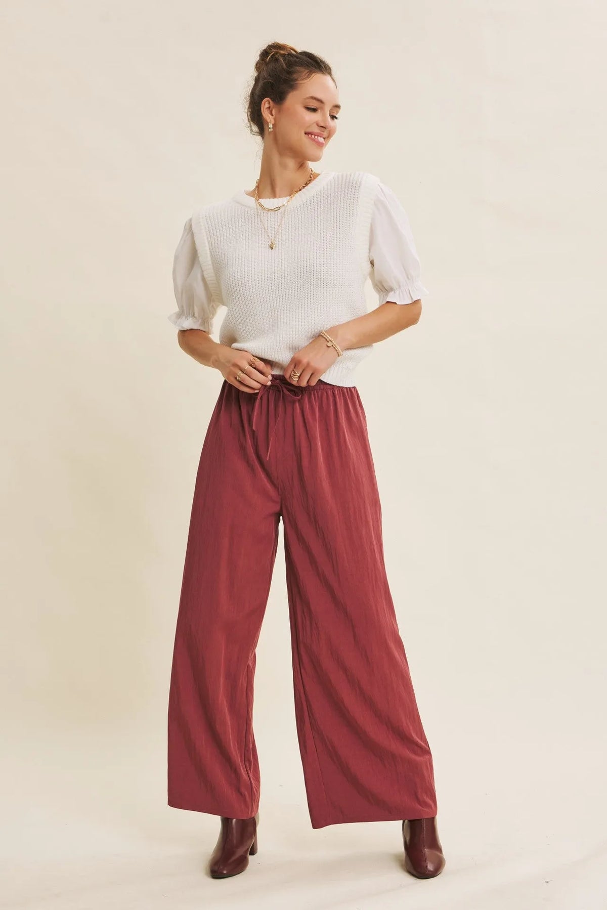 Wide leg pants in maroon with elastic waistband and soft flowing fabric featuring a step washed texture
