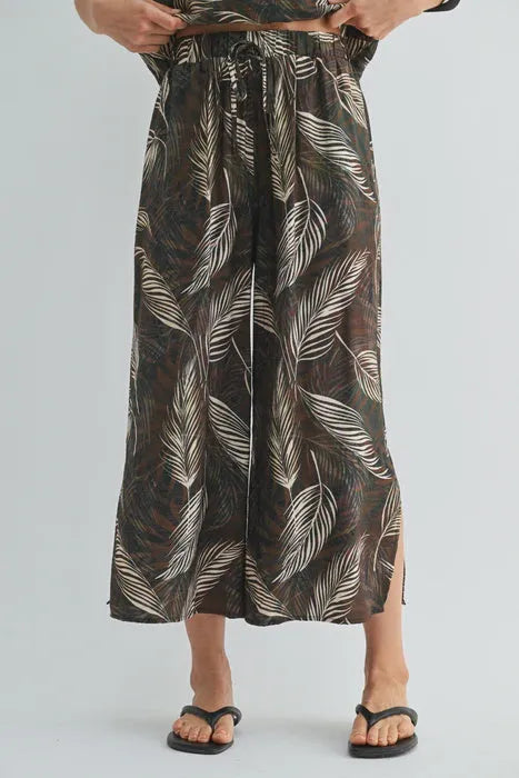 A flowing wide-leg maxi skirt in dark brown with an elegant white leaf print elastic waist design