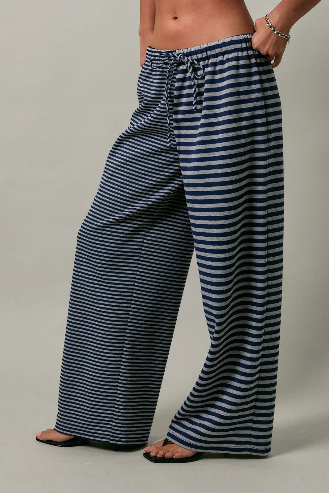 Low rise stripe front tie pants with navy and light gray wide-leg stripes and elastic waistband with drawstring