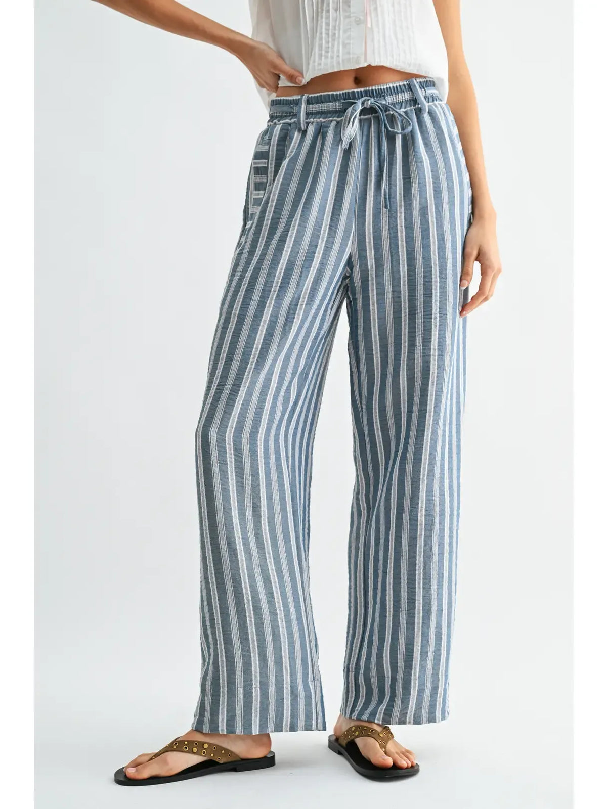 Striped wide leg drawstring pants in soft blue and white vertical stripes with elastic waistband and drawstring tie