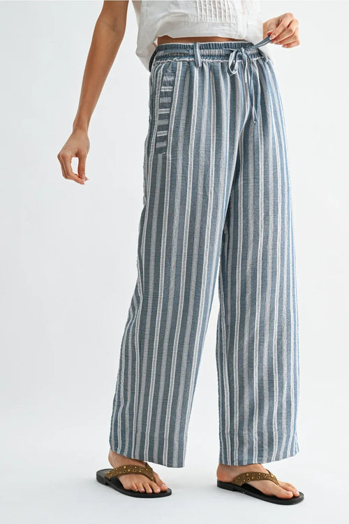 Striped wide leg drawstring pants in soft blue and white vertical stripes with elastic waistband and drawstring closure
