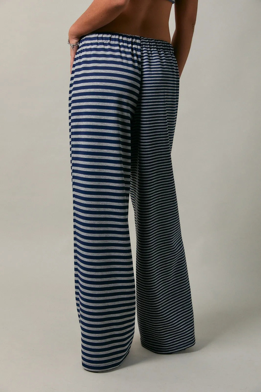 Low rise stripe wide-leg trousers with navy and light gray horizontal stripes and elastic waistband