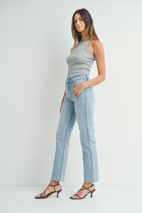 Woman wearing high waist straight leg denim jeans and black strappy kitten heels