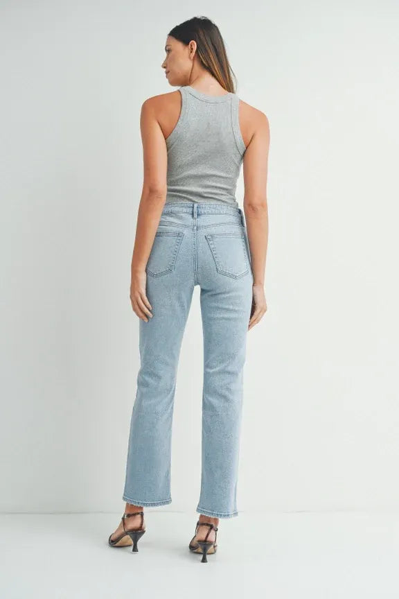 Woman wearing grey tank top and light blue high waist straight leg denim jeans