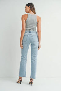 Woman wearing grey tank top and light blue high waist straight leg denim jeans