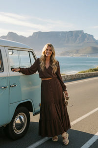 Woman in Saltwater Luxe Jaycee midi skirt beside vintage blue van