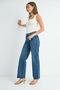 Woman wearing a ribbed square-neck tank top with high-rise relaxed fit straight leg denim jeans