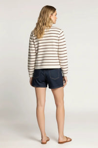 Woman in Thread and Supply classic striped cardigan jacket with denim shorts