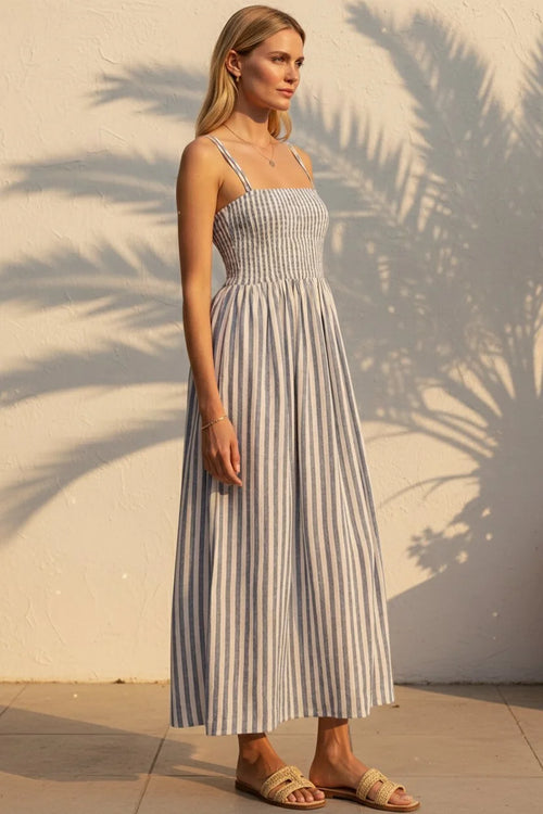 Woman in Nadine striped maxi dress with blue white vertical stripes